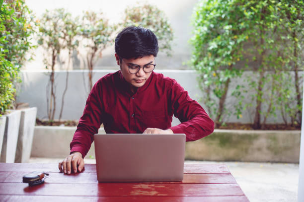 istock Communication and checking working hours An Asian man is working on a laptop and is devoted to planning the work. Successful businessmen Business and team work concept 1304209718