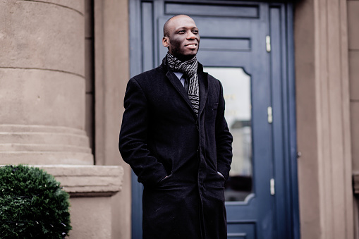 portrait of a african businessman standing outdoors in city