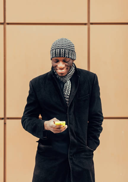 istock Young afro black man holding a smart phone 1304210346