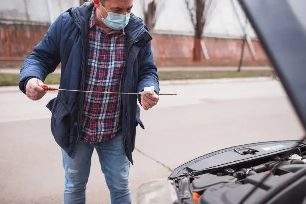 Photo of Man checking motor oil