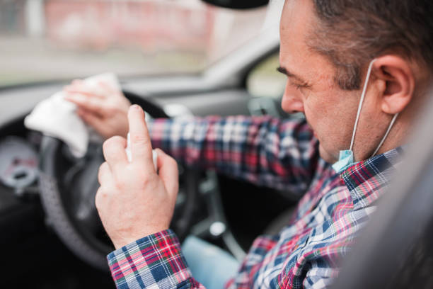 istock Car driver  disinfecting steering wheel 1304212286