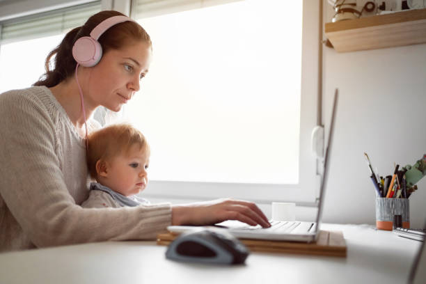 istock Mother with baby boy working in home office 1304213721