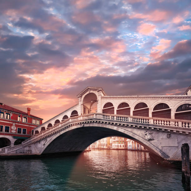 rialto bridge on the grand canal in venice, italy in the evening on sunset. toned square image. romantic sights of venice in italy - venice italy canal famous place grand canal imagens e fotografias de stock