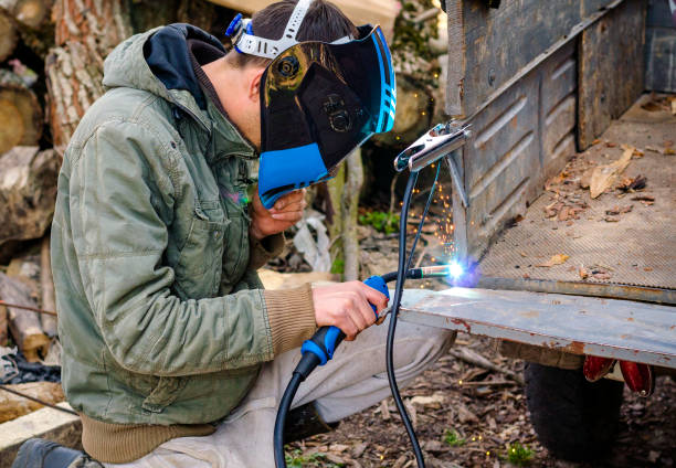 istock welder works at home in a protective mask without gloves 1304219171