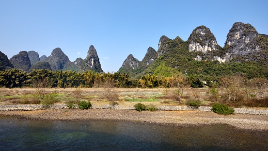 China - East Asia,Guilin,Yangshuo county,Yangdi township,\nXingping town.\nGuilin karst has been included in the world heritage list.\nKarst landform scenery along the Li River,From Guilin to Yangshuo,It is 63 km in length and divided into three sections:\nGuilin-Yangdi,Yangdi-Xingping,\nXingping-Yangshuo.It's the most beautiful landscape waterway has about 15 km,It goes from Yangdi to Xingping.\nHere the Li River snakes through a fairy-tale landscape of conical limestone peaks,its smooth waters exquisitely mirroring the magical.\nLijiang River and its tributaries,the shuttle in the \nShiShanfeng forest,mountains and water and hold,very beautiful.\nBeautiful Lijiang River,is the world's largest and most beautiful karst landscape scenic resort.\nGuilin is the country a shining pearl in the mountains and rivers, unique and beautiful Lijiang River karst making it a world-famous tourist destination.\nLarge numbers of tourists visit the Li river by yachts every year.