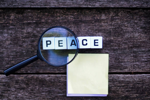istock PEACE Word on Dark Wooden Background. 1304222217