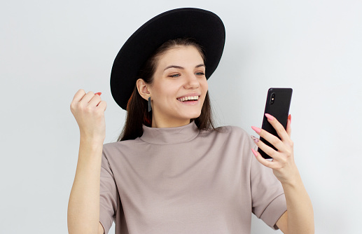 European woman successful social media marketers and holding a smart phone, beauty face, white background.
