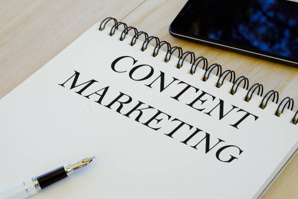 istock Business and technology concept. Mobile phone,pen and notebook written with Content Marketing. 1304224581