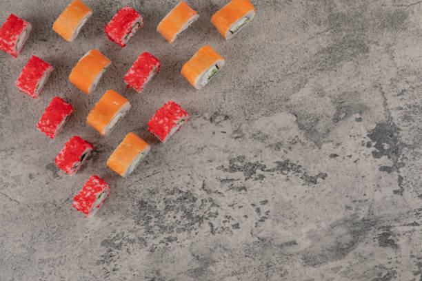 istock Bunch of delicious sushi rolls placed on marble background 1304226046
