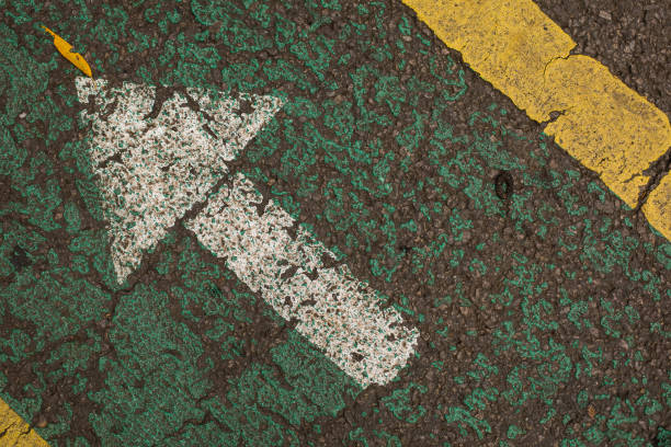istock White arrow painted on the ground 1304226358