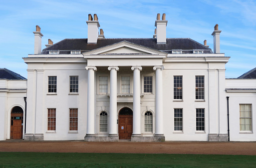 Public Hylands park with house, mansion or stately home and grounds with drive and lawn. Bridgerton style neo classical regency Georgian Palladian villa. Front elevation and main entrance. Outdoors on a bright winters day. Chelmsford, Essex, United Kingdom, November 22, 2021