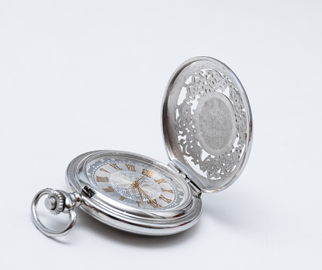 beautiful silver pocket watch close up on white background