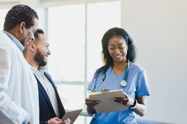 istock Diverse healthcare professionals share laugh during workday 1304228911