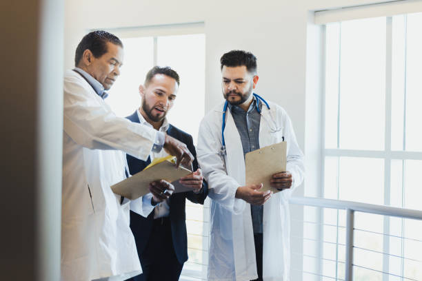 istock Three men discuss hospital procedures 1304228920