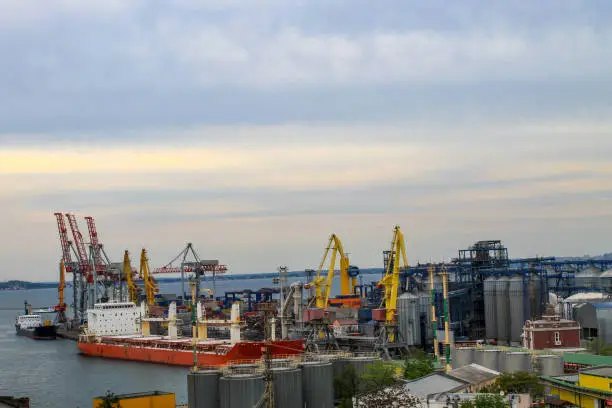 Hoisting cranes and industrial ships at cargo sea port in Odessa, Ukraine