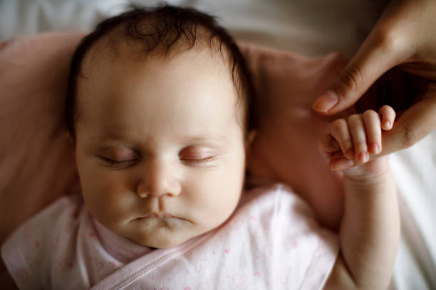 istock Newborn baby holding mother's hand 1304231038
