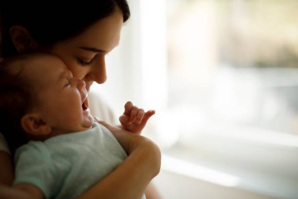 istock Newborn baby crying in mother hands 1304231244