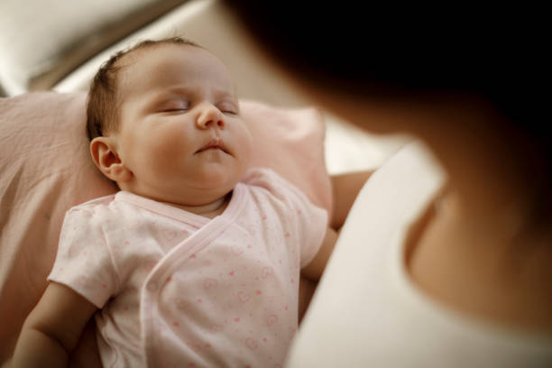 istock Mother holding her sleeping baby gir 1304231290