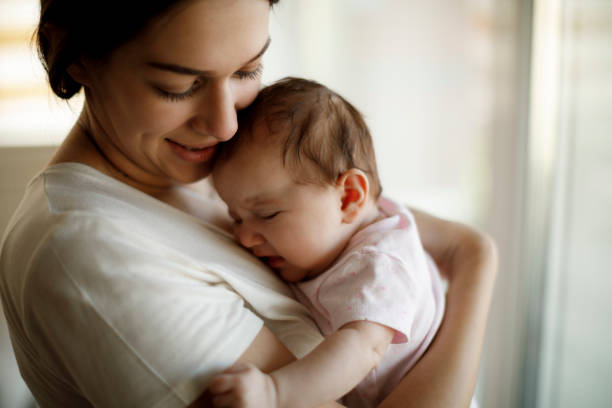 istock Newborn baby crying in mother hands 1304231332