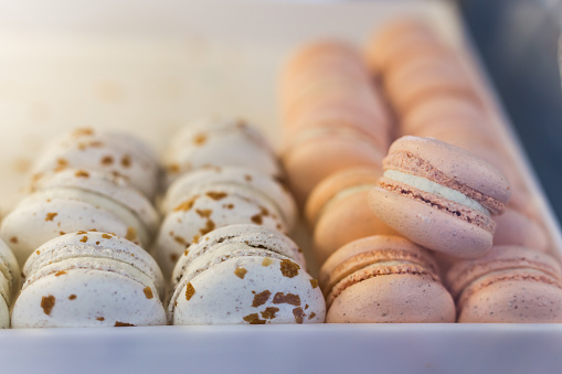 Fresh colored macaroons close-up, sale in coffee shop showcase