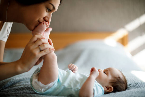 istock Happy mother playing with her baby 1304231369