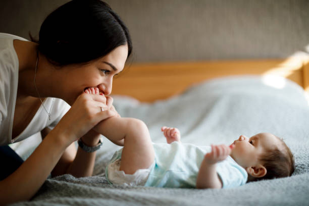 istock Happy mother playing with her baby 1304231408