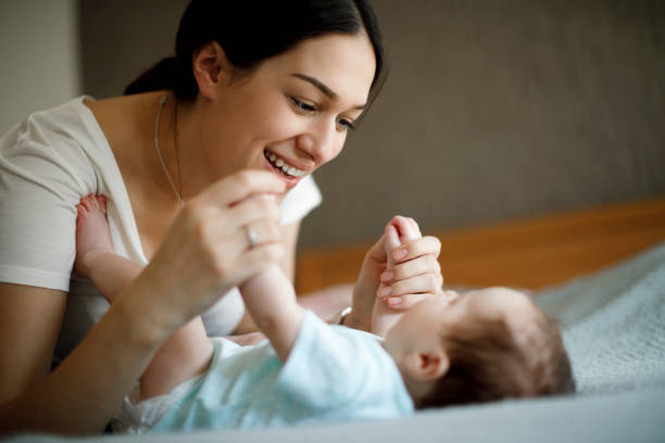 istock Happy mother playing with her baby 1304231483