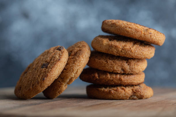 istock Stack of delicious chocolate chip cookies on wooden board 1304233863