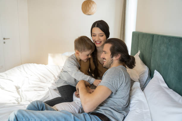 istock Family sitting together at the bed while playing 1304234599