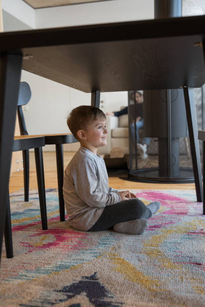 Kid playing at the peekaboo with his parents