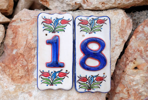 istock House number 18 on the stone wall 1304235625