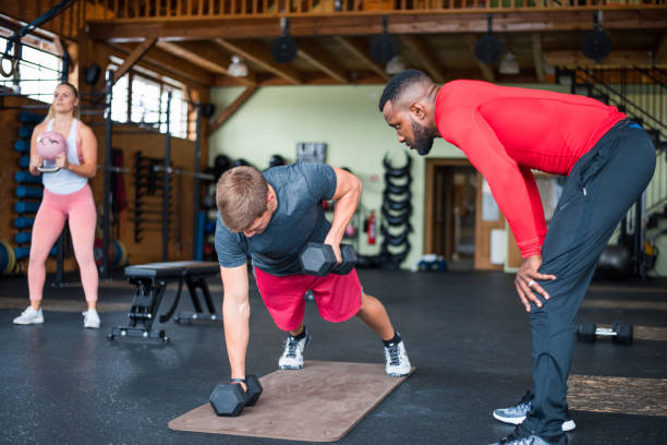 istock Young man exercising with dumbbells 1304236226