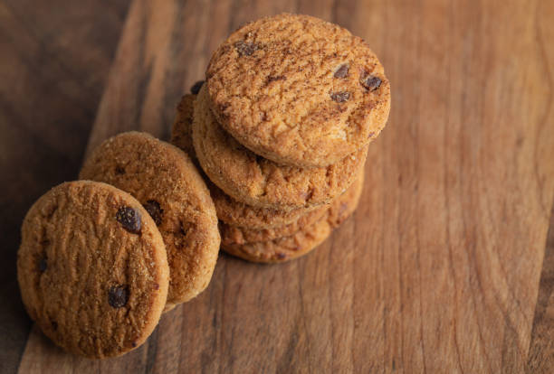 istock Stack of delicious chocolate chip cookies on wooden board 1304237201