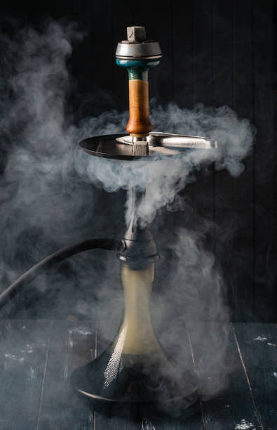 istock Hookah in smoke on dark wooden background 1304237305