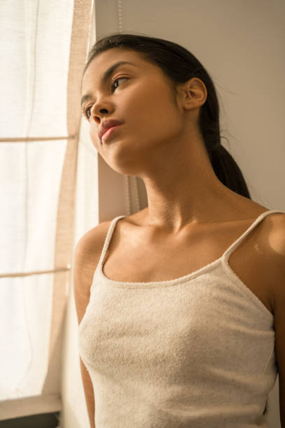 istock Woman standing near the window and thinking 1304240931