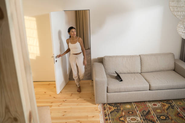istock Girl standing at the doors in modern apartment 1304240949