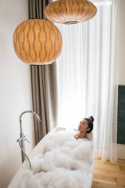 istock Woman laying around soap foam and smiling 1304240975