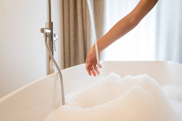 istock Female checking the water temperature with her hand 1304242217