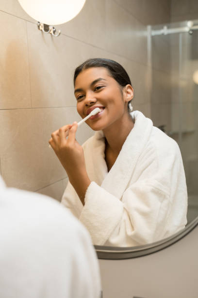 istock Girl brushing her teeth and enjoying morning routine 1304242218