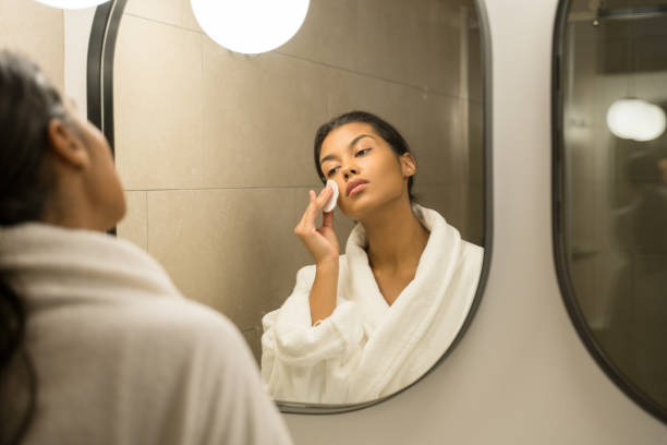 istock Girl wipes her face with a cotton pad 1304242238