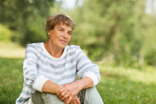 istock happy Senior caucasian woman sitting  outdoors. copy space 1304244807
