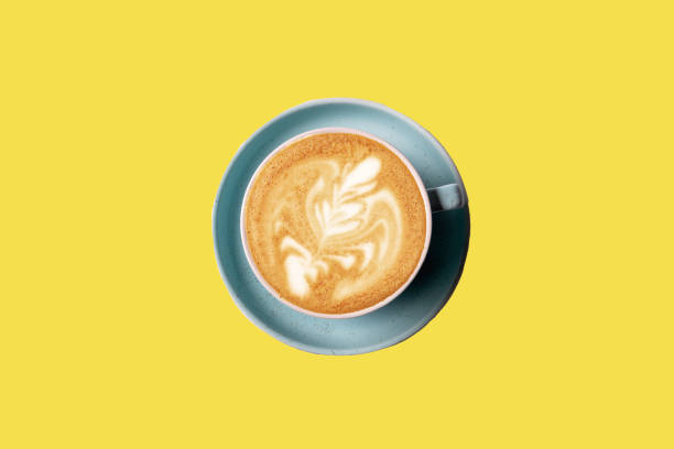 istock Flat lay latte art coffee in a cup isolated on yellow background. 1304245981