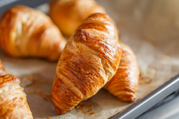 istock Croissant on tray - freshly baked pastry 1304247439