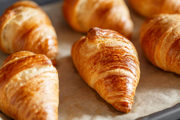 istock Croissant on tray - freshly baked pastry 1304247449