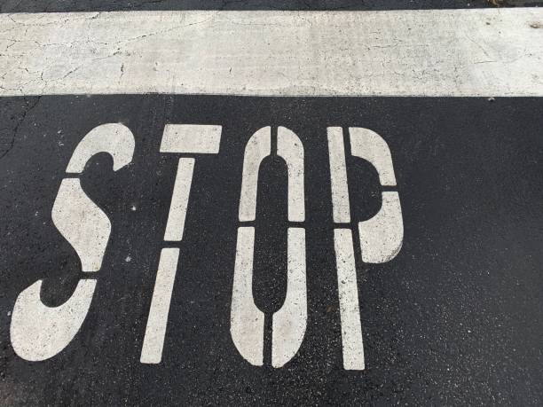Colorful chalk drawing on sidewalk: yellow word STOP and pieces of chalk