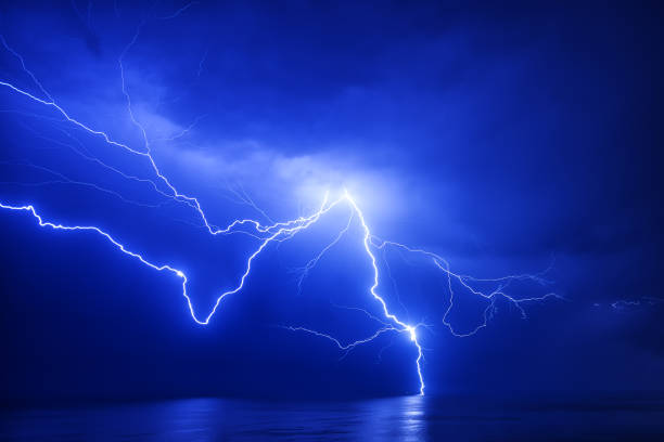 istock A huge branched lightning strikes the sea near a distant ship with a reflection 1304249943