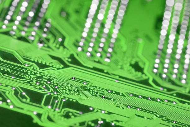 istock Green printed circuit board with selective focus and shiny pins bokeh background, diagonal composition 1304250006