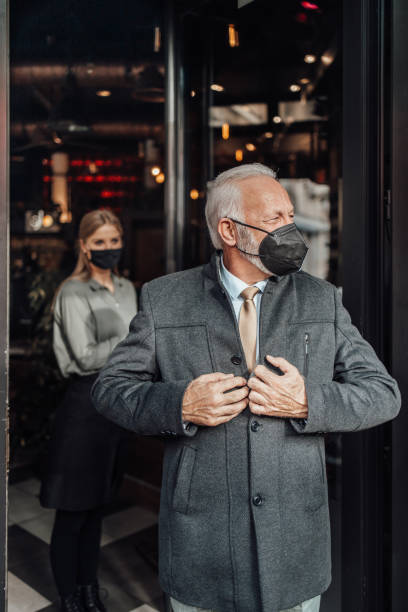 istock Senior business man leaving restaurant 1304251408