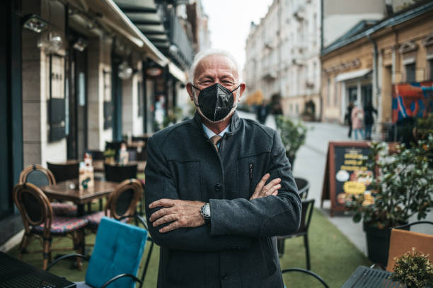 Senior business man standing on empty street