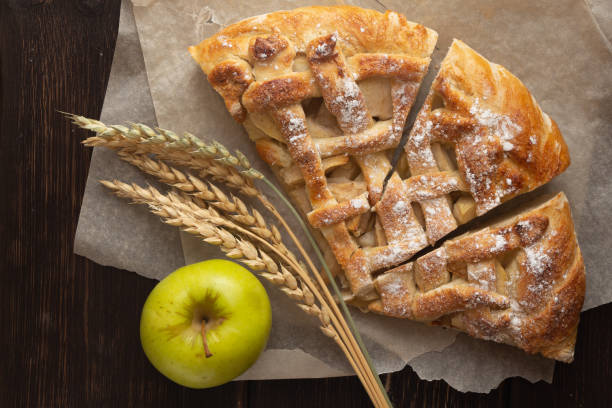 istock Apple pie cooked Green apple with wheat stalks on a dark background 1304253035